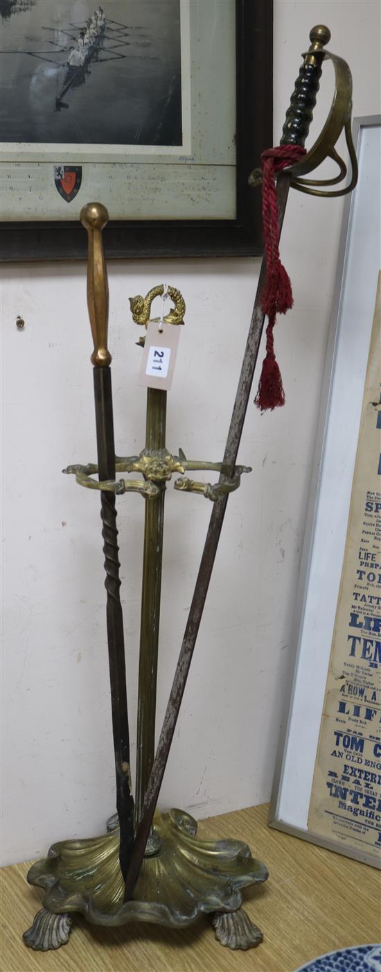 A brass stick stand, replica sword and poker